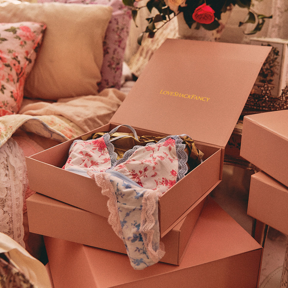 LoveShackFancy underwear hanging out of a gift box