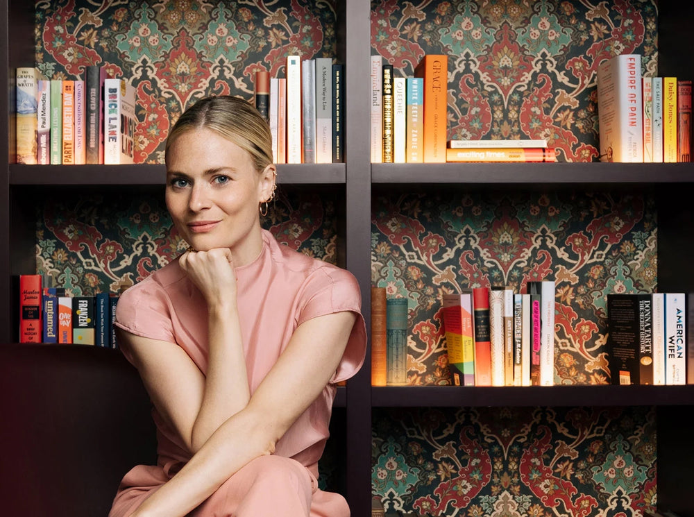 Pandora Sykes sat in front of a bookcase