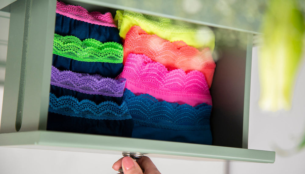 An open drawer filled with folded knickers