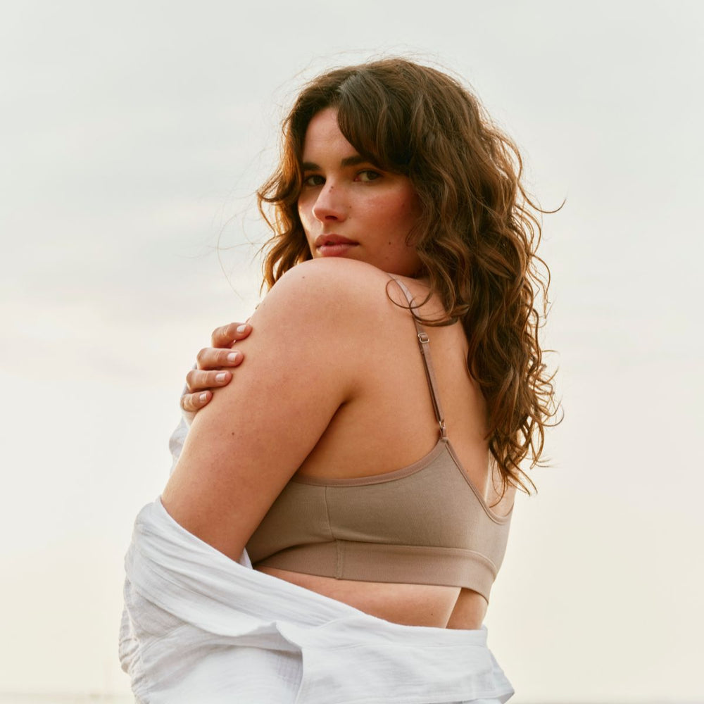 woman in brown bra with sky backdrop